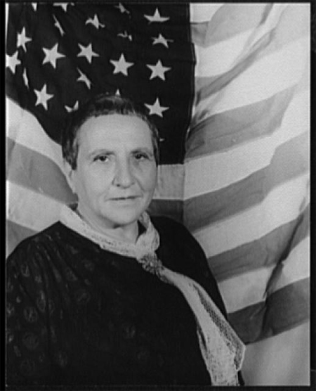 Portrait of Gertrude Stein, with American flag as backdrop