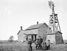 Family in front of farm home, Buffalo County, Nebraska