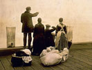 Four immigrants and their belongings, on a dock, looking out over the water