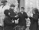 New York, New York. Italian-American children warming their hands outside a fruit store at First Avenue and Tenth Street