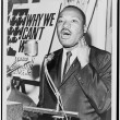 Martin Luther King, Jr., three-quarter-length portrait, standing, facing front, at a press conference