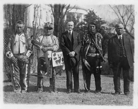 President Calvin Coolidge posed . . . with four Osage Indians