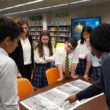 DCD School 8th graders collaborated in the library to analyze primary sources from a summer teacher institute that history teacher Victoria Marcone attended at Library of Congress