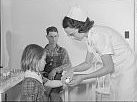 Nurse treating child in health clinic