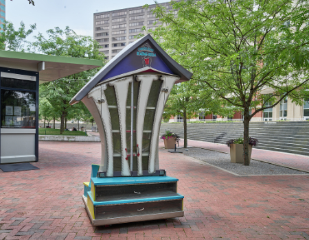 a large version of “little free libraries” — where passersby may leave or take a free book — in the courtyard of Triangle Park in downtown Lexington, Kentucky