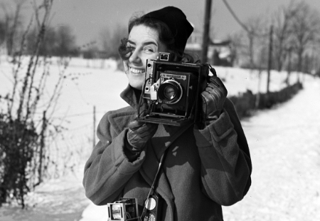 Woman behind a camera in the winter